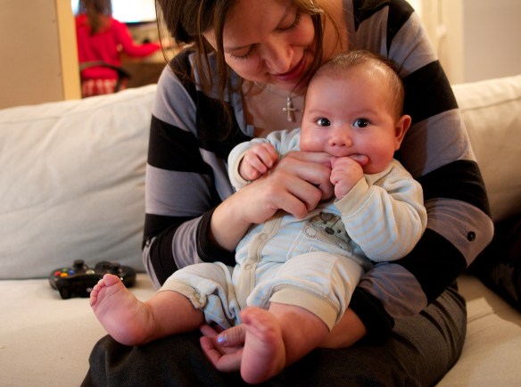 baby chews on a finger